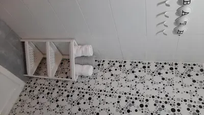 a bathroom with a shower with black and white tiles at Tamesna HOUSE in Sidi Yahia az Zaʼer