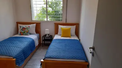 two beds in a small room with a window at Tamesna HOUSE in Sidi Yahia az Zaʼer