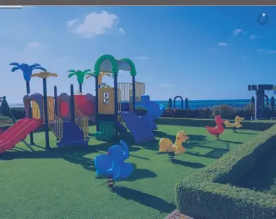 a playground with a bunch of animals in the grass at Appartement pieds dans l’eau Tamaris in Casablanca