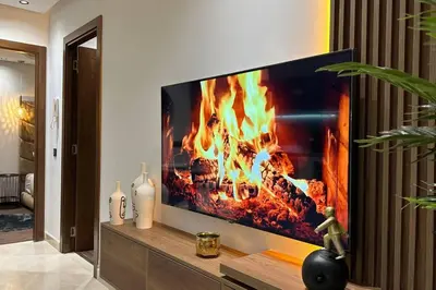 a living room with a tv with a fire in it at Luxurious 2 Suites Apt - By AppartAli in Casablanca