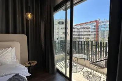 a bedroom with a bed and a balcony with a view at Luxurious 2 Suites Apt - By AppartAli in Casablanca