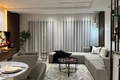 a living room with a couch and a table at Sunny 2 Bedrooms - By AppartAli in Casablanca