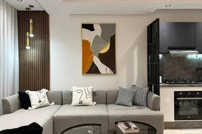 a living room with a couch and a table at Sunny 2 Bedrooms - By AppartAli in Casablanca