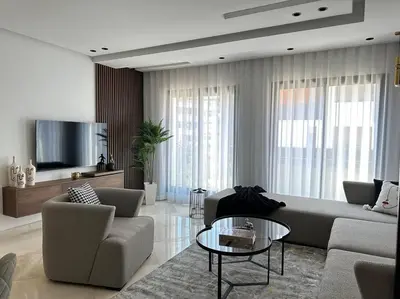 a living room with a couch and chairs and a tv at Sunny 2 Bedrooms - By AppartAli in Casablanca