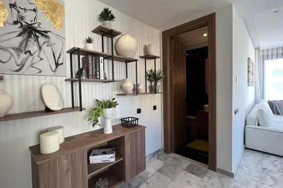 a living room with shelves on the wall at Casablanca Downtown 21 - By AppartAli in Casablanca