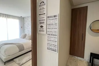 a bedroom with a bed and a sign on the wall at Casablanca Downtown 21 - By AppartAli in Casablanca