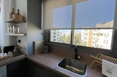 a kitchen with a sink and a large window at Casablanca Downtown 21 - By AppartAli in Casablanca