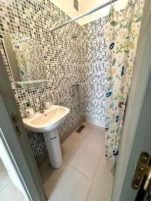 a bathroom with a sink and a shower at chez mehdi in Skhirat