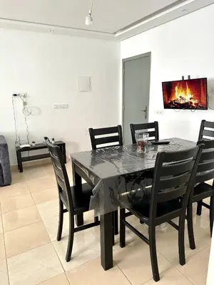 a black dining room table with black chairs at chez mehdi in Skhirat