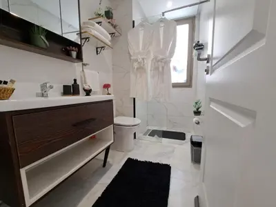 a white bathroom with a sink and a toilet at Studio Casablanca aéroport nouaceur in Nouaceur