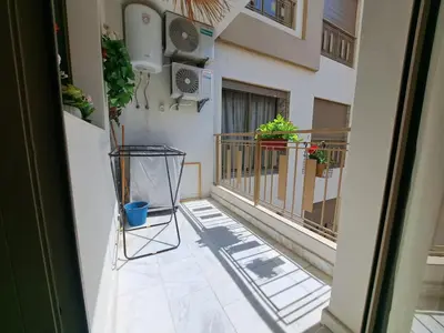 a balcony with potted plants on a building at Studio Casablanca aéroport nouaceur in Nouaceur