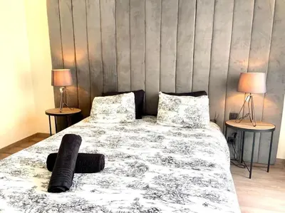 a bedroom with a bed and two tables with lamps at Eden Luxury Anfa-Big Apt 3 Bedrooms/Massira Avenue in Casablanca