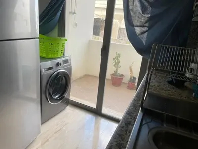 a kitchen with a washing machine in a kitchen at APPARTEMENT HAUT STANDING proche gare casa voyageur in Casablanca