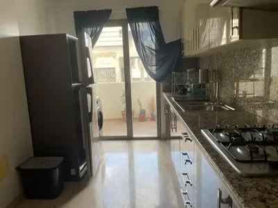 a kitchen with a sink and a stove top oven at APPARTEMENT HAUT STANDING proche gare casa voyageur in Casablanca
