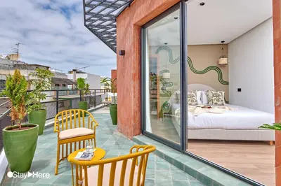 a balcony with a bedroom and a bed on it at Stayhere Casablanca - Maarif - Elite Residence in Casablanca