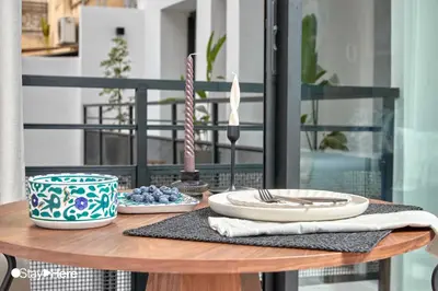 a table with plates and utensils on a balcony at Stayhere Casablanca - Maarif - Elite Residence in Casablanca