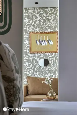 a living room with a couch and a picture of birds at Stayhere Casablanca - Maarif - Elite Residence in Casablanca
