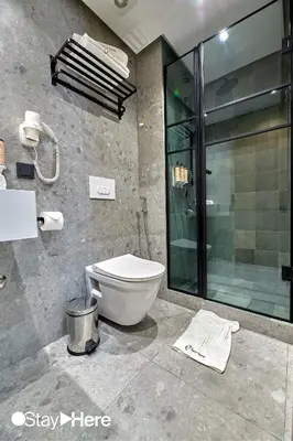a bathroom with a toilet and a glass shower at Stayhere Casablanca - Maarif - Elite Residence in Casablanca