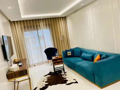 a living room with a blue couch and a table at Atlantic Suite View 3 in Casablanca