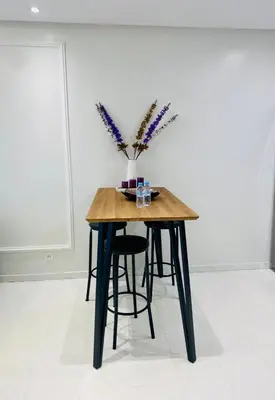 a wooden table with chairs and a vase of flowers at Atlantic Suite View 3 in Casablanca