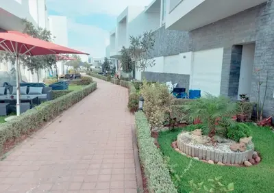 a brick walkway in front of a building at Appartement luxueux et moderne à sidi Rehal in Dar Hamida