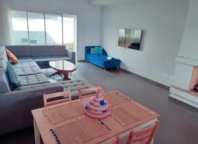 a living room with a couch and a table at Appartement luxueux et moderne à sidi Rehal in Dar Hamida