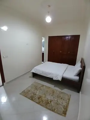 a small bedroom with a bed and a rug at Appartement Casa Voyageurs in Casablanca