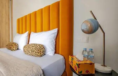 a bedroom with a bed with a large orange headboard at Atlantic Suite View 1 in Casablanca