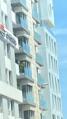 a tall white building with blue balconies on it at Atlantic Suite View 1 in Casablanca