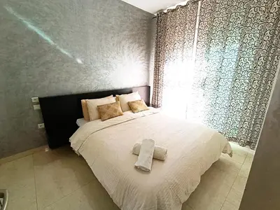 a bedroom with a bed with two towels on it at rabatapartmentresidence in Rabat