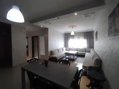 a living room with a couch and a table at rabatapartmentresidence in Rabat