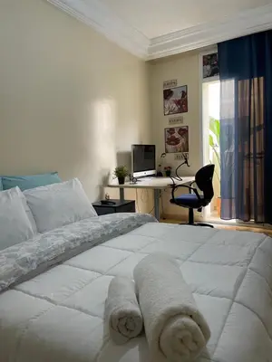 a bedroom with a white bed with towels on it at Private room in Casablanca