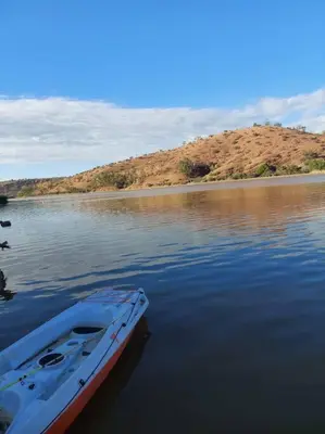 a boat sitting in the middle of a body of water at Lake House Boulaouane in El Jadida