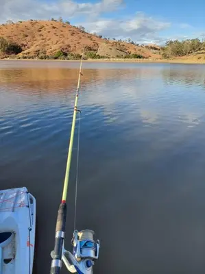 a boat with a fishing pole in the water at Lake House Boulaouane in El Jadida