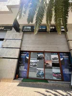 a building with a bunch of signs on the side of it at Magnifique duplex moderne à 1 minute à pied de la plage- Résidence Miramar Mohammedia in Mohammedia