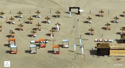 an overhead view of a beach with chairs and umbrellas at Cosy Apartment with sea view in Sidi Rahal