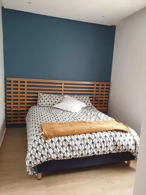 a bedroom with a bed with a blue wall at Appartement Front de mer avec vue Panoramique in Casablanca