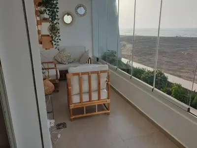 a room with a balcony with a view of the ocean at Appartement Front de mer avec vue Panoramique in Casablanca