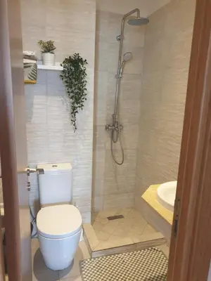 a bathroom with a toilet and a shower and a sink at Appartement Front de mer avec vue Panoramique in Casablanca