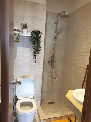 a bathroom with a toilet and a shower and a sink at Appartement Front de mer avec vue Panoramique in Casablanca