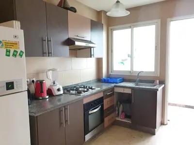 a kitchen with a sink and a stove top oven at Mosquée & Foire by Saloua in Casablanca