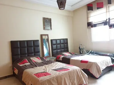 a bedroom with two beds and a window at Mosquée & Foire by Saloua in Casablanca