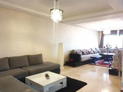a living room with a couch and a table at Mosquée & Foire by Saloua in Casablanca