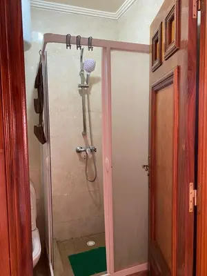 a shower stall in a bathroom with a toilet at Appartement mohamedia Ricoflores vue sur piscine in Mohammedia