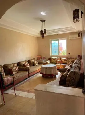 a large living room with couches and a table at Appartement mohamedia Ricoflores vue sur piscine in Mohammedia
