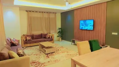 a living room with a couch and a table at Appartement Costa Bouznika in Bouznika