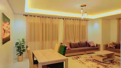 a living room with a couch and a table at Appartement Costa Bouznika in Bouznika
