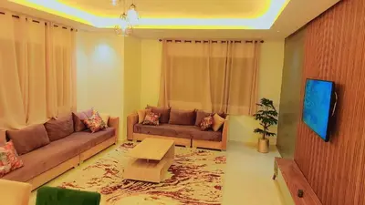 a living room with a couch and a table at Appartement Costa Bouznika in Bouznika