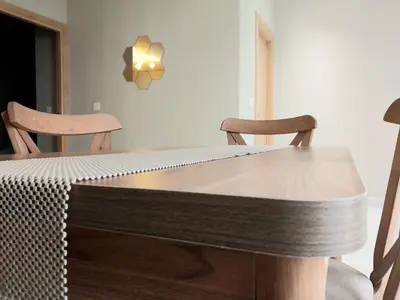 a dining room table with two chairs at Cosy appartement proche de l'aéroport mohamed 5 in Deroua