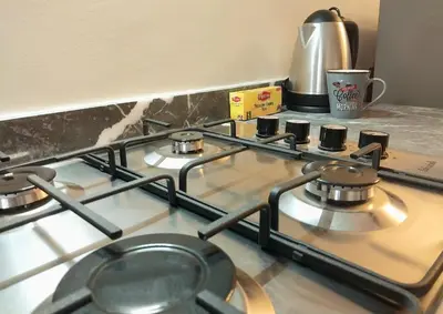 a stove top with a pot on top of it at Cosy appartement proche de l'aéroport mohamed 5 in Deroua